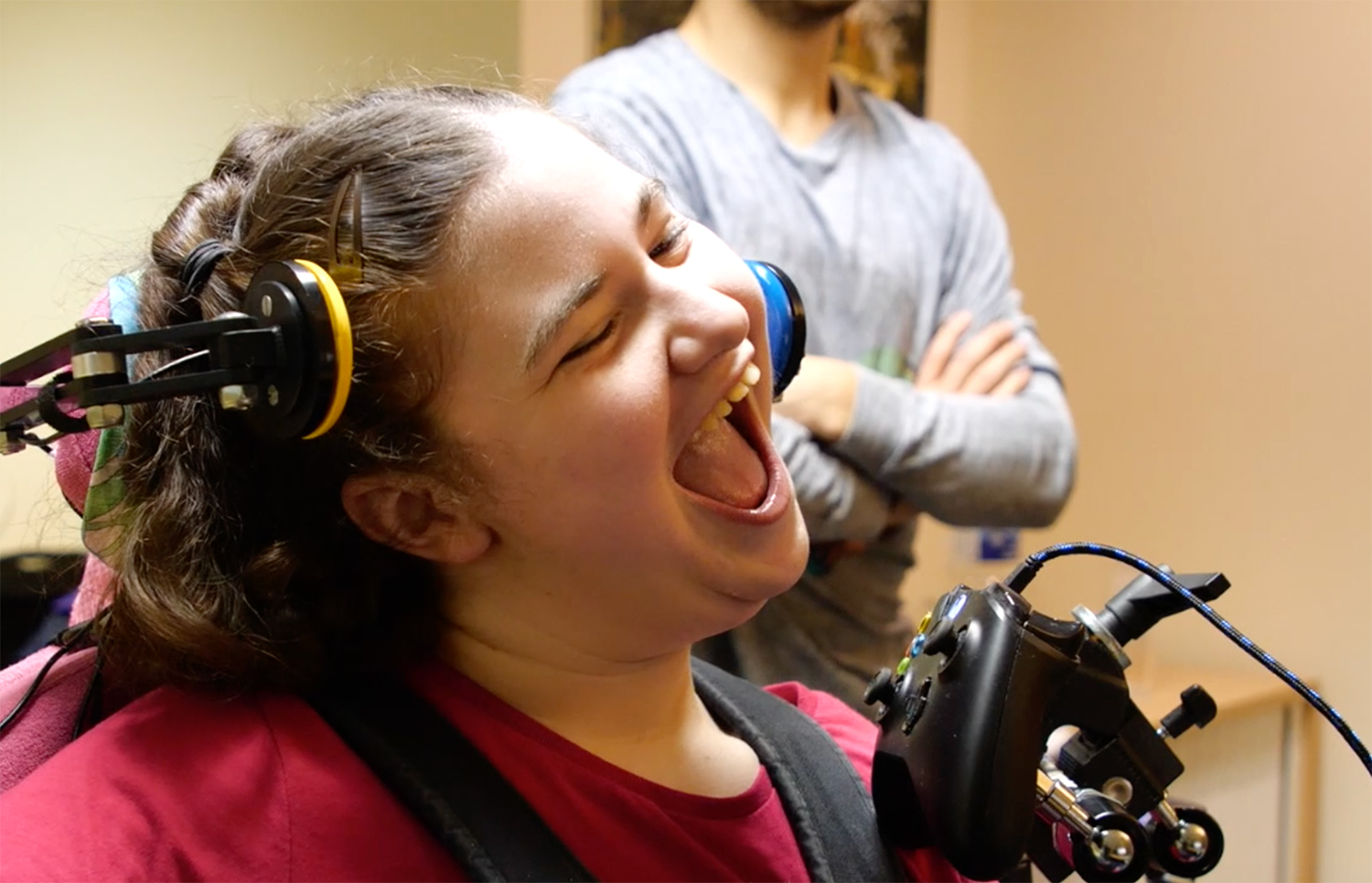 Close up of laughing girl and adapted games controller