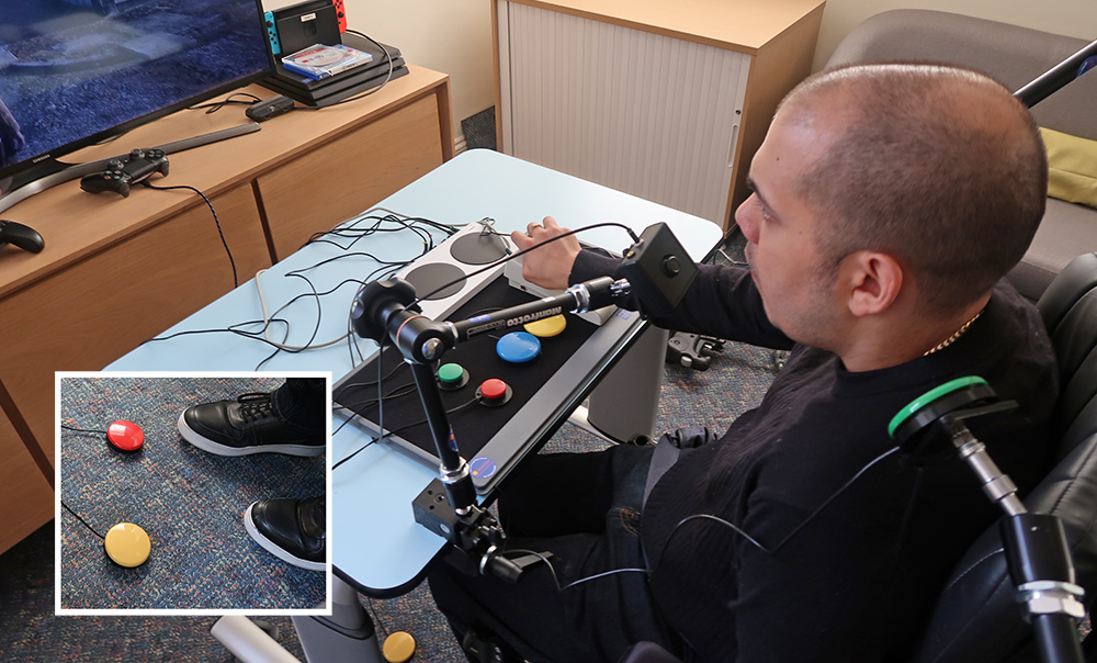 Man using complex joystick and switch gaming setup on a table