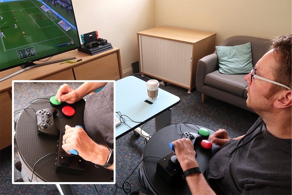 Seated man playing football video game. Inset shows close-up of hands and controller