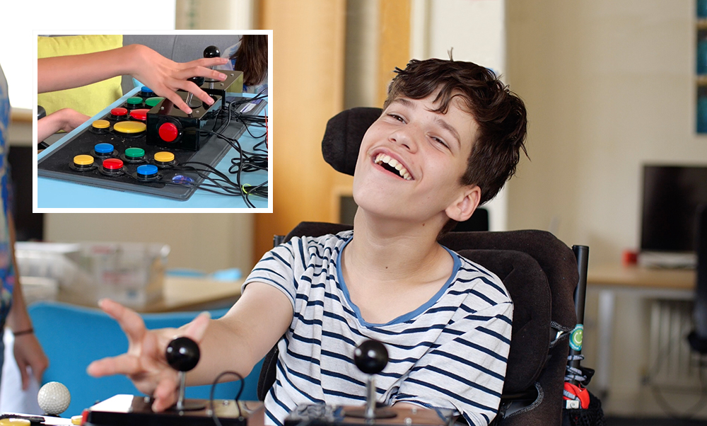 Smiling boy in wheelchair holding games joystick, inset shows tray of 16 switches and two joysticks