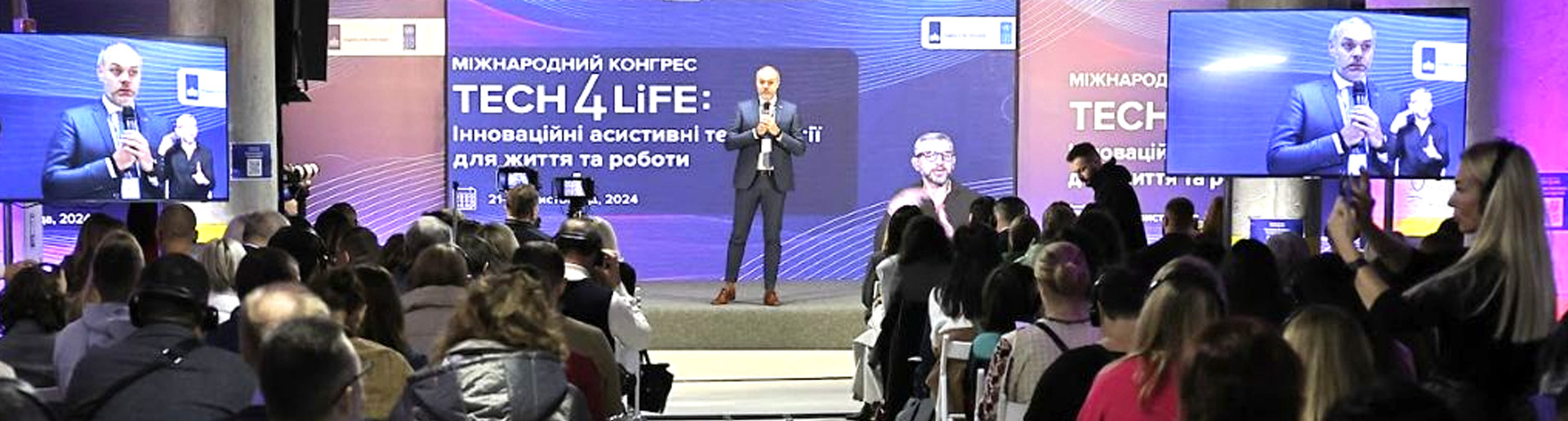 Man speaks to an audience at the conference