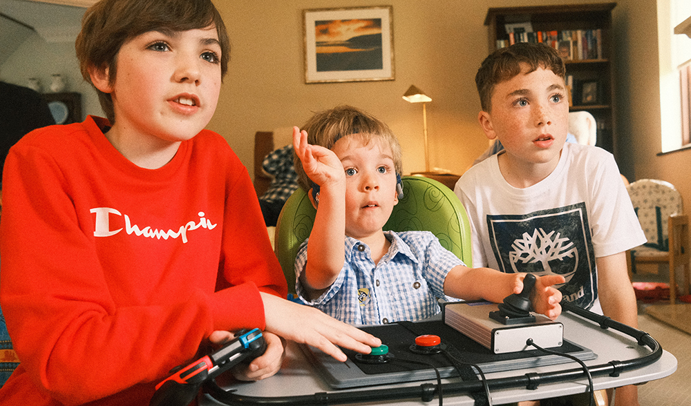 Three young boys playing games together