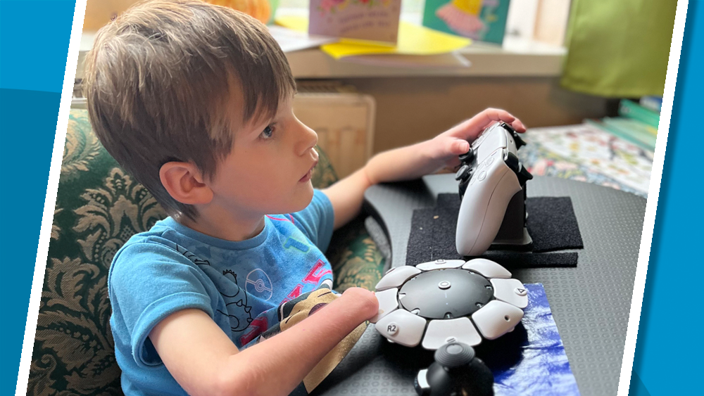 Young girl using two adapted gaming controllers