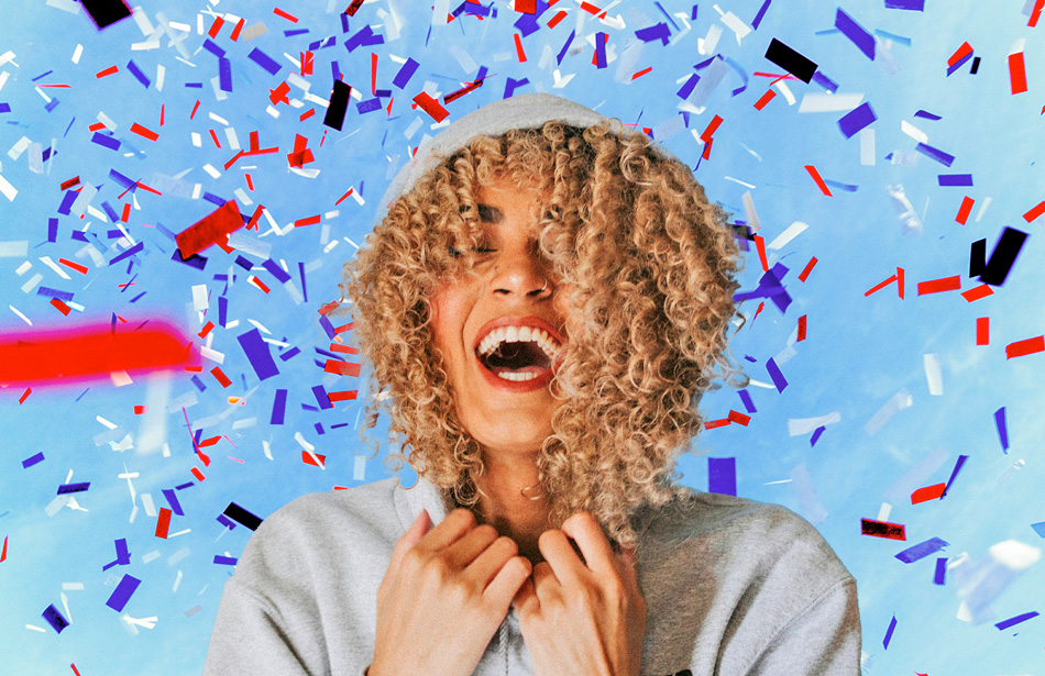 Smiling girl among confetti shower