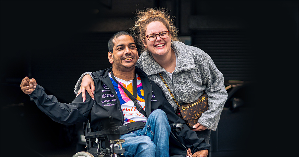Smiling man in wheelchair with smiling woman