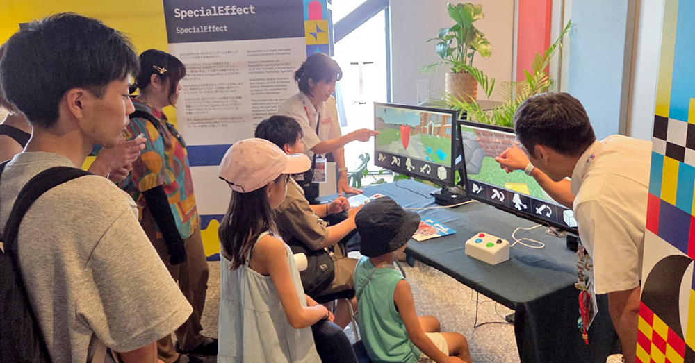 Group of people crowd around an video game demo exhibition display